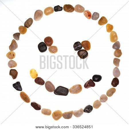 Emoji (emoticon) Of Smiling Face Made By Hand With Stones (boulders). Isolated On White Background. 
