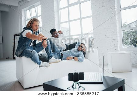 Look At That Photograph. Buddies Have Set Self Timer Smartphone On The Table In Front Them.