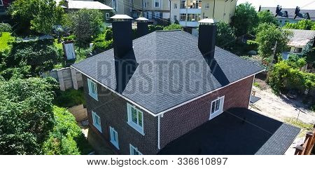 House With A Roof From A Bituminous Tile. Bituminous Tile For A Roof. A Roof From A Bituminous Tile.