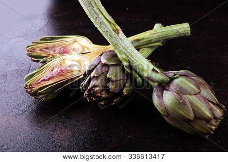 Artichokes On Rustic Background. Fresh Raw Organic Artichoke Flower.
