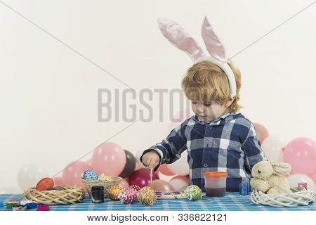 Funny Little Boy With Bunny Ears And Colorful Easter Eggs. Easter Holiday. Colouring Eggs For Easter