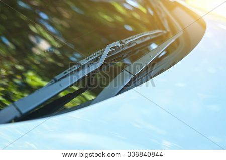 Section Of The Front Of A White Vehicle And Its Front Windscreen Bonnet And Wipers.