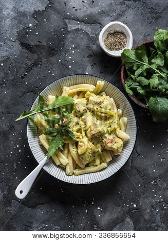 Curried Creamy Salmon With Pasta On A Dark Background, Top View