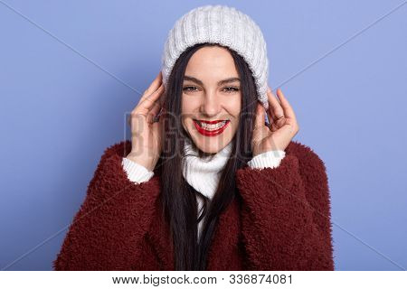 Closeup Portrait Of Beautiful Adorable Brunette With Red Lips, Putting Her White Hat On, Enjoying Re