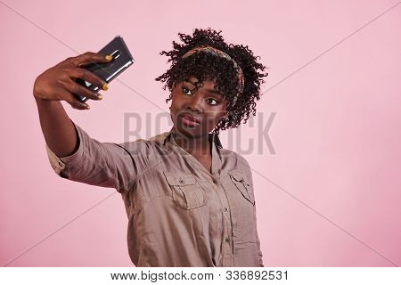 Yellow Painted Fingernails. Attractive Afro American Woman In Casual Clothes Takes Selfie At Pink Ba