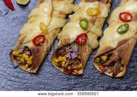 Overview Of Baked Enchiladas With Salsa On Slate