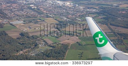 Plane Flying Over Amsterdam Airport Area, View Out Of Airplane Window.