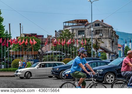 Shkoder, Albania - June 21, 2021: Traffic On The Road In Front Of Luigi Gurakuqi Statue In Shkoder. 