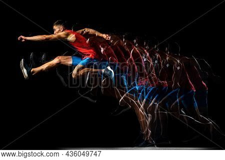 Full-length Portrait Of Young Man, Professional Track Athlete, Runner In A Jump, Training Isolated O