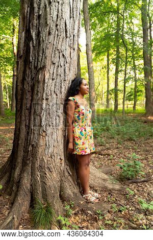 Full Body Portrait Of A Beautiful Happy Mixed Race African American Woman Wearing A Yellow Floral Dr