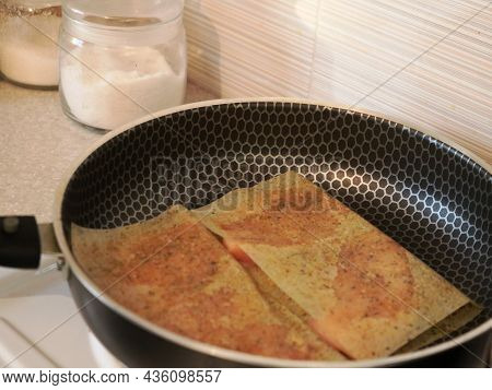 Frying Meat In Sheets Soaked In Spices And Oil In A Pan Close-up, Preparing A Fried Meat Dish In The
