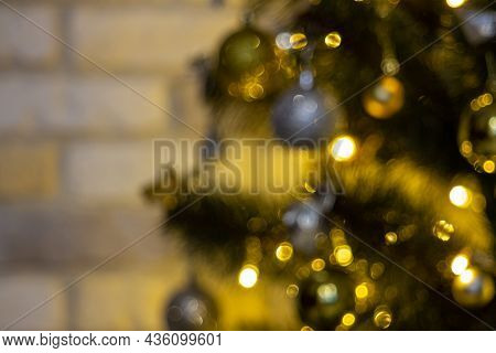 Defocused Christmas Tree Garland Illumination. Blurred Sparkling Fairy Background. Silver And Gold L