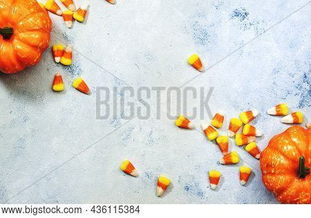 Halloween Pumpkin And Candy Corn Banner On Blue Baclground. Top View With Copy Space