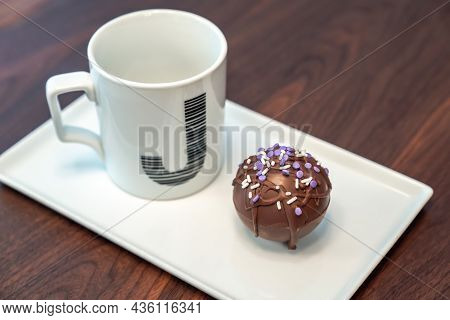 Close Up Food Photograph Of A Hot Cocoa Bomb Covered In Drizzled Brown Chocolate And Purple And Whit