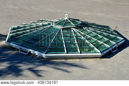 Polygonal Window At Ground Level In The Shape Of A Hexagonal Pyramid With Ventilation In The Shape O