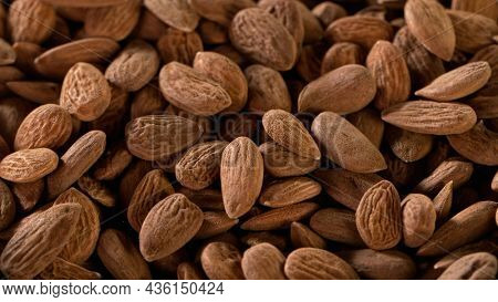 Raw organic almonds nuts, close-up, macro shot.