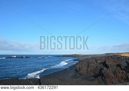 Beautiful Waves Rolling Ashore On A Black Lava Rock Sand Beach.