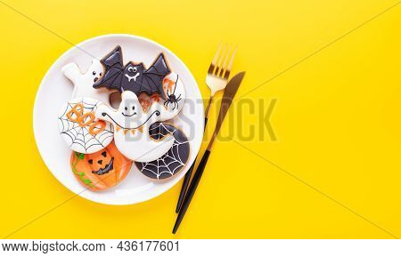 Halloween Table Setting With Gingerbread Cookies On White Plate And Cuterly On Yellow Background. Br