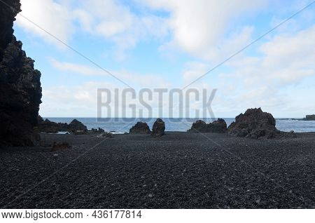 Large Black Lava Rock Formations On Dritvik Beach In Iceland.