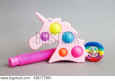 Colorful Antistress Sensory Fidget Toys On A Gray Background
