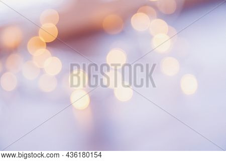 Many Blurred Small Electric Bulbs On A Wall. Yellow Blurred Lights. Wall Of Christmas Lights
