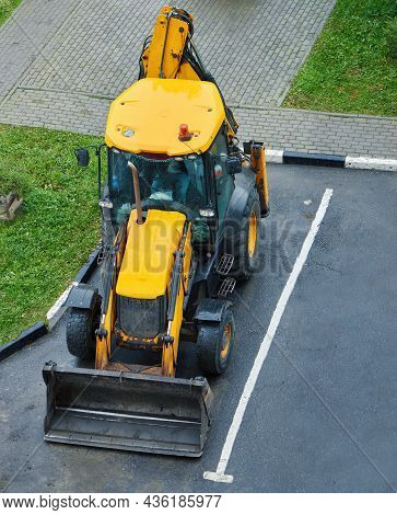 Yellow Tractor Stays On Parking Place. Heavy Indastrial Machines. Top View.