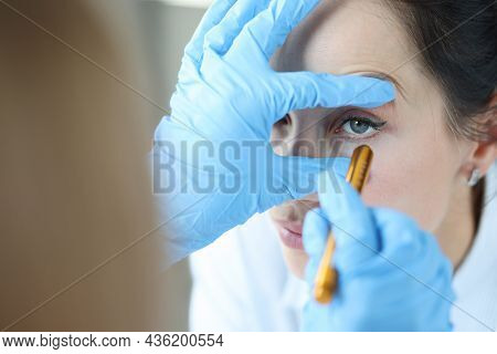 Doctor Shines Light Into Patient Eye To Check Pupil Closeup