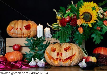 Orange Pumpkins With Scary Jack Olantern Face. Autumn Fall Concept: Pumpkins, Candles, Sunflower, Le