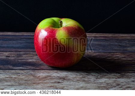 Red Apple Casting Shadow On A Table