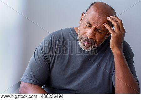 Older Man Not Feeling Well And Having A Headache.