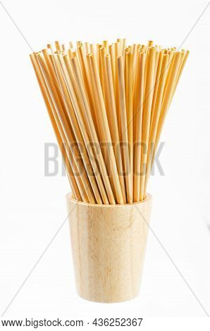 Wheat Straw For Drinking Water In Wooden Glass On White Background. Zero Waste Concept.