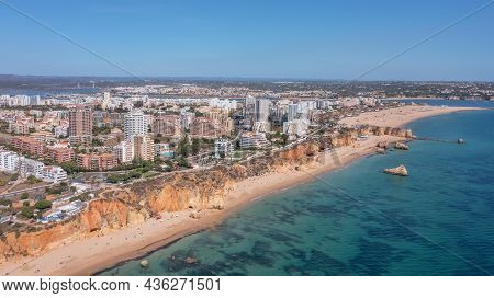 Aerial View Of The Wide And Crowded Portuguese Famous Rocha Beach In Portimao, Algarve, Portugal. Dr