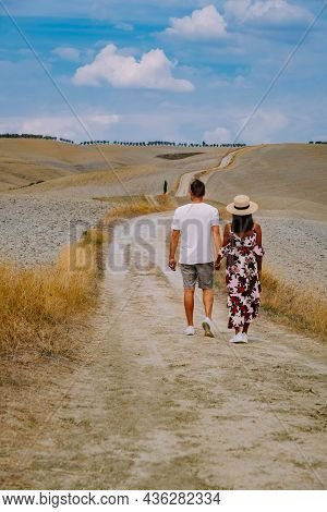 Couple Man And Woman On Vacation In Italy Toscane Watching The Golden Hills Of Toscane In Italy Euro