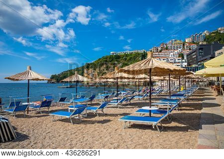 Budva, Montenegro - September 18, 2021: Beach Of Old Town Budva. Ancient Walls And Tiled Roof Of Old