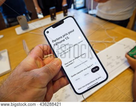 Paris, France - Sep 24, 2021: Man Holding New Iphone 13 At The Apple Store As Latest New 5g Iphone 1