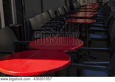 Empty Street Cafe. Round Red Tables With Gray Chairs.