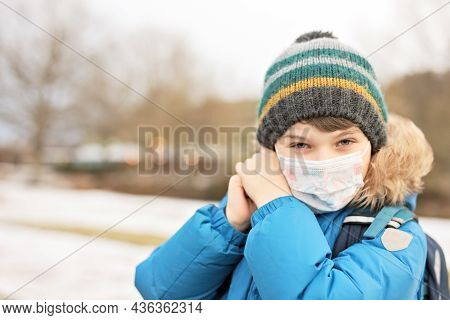 Kid Boy Wearing Ffp Medical Mask On The Way To School. Child Backpack Satchel. Schoolkid On Cold Aut