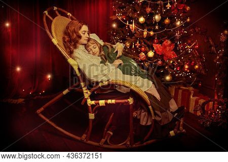 Christmas fairy tales. Portrait of a caring mother lulling her beloved little daughter in a rocking chair by a decorated Christmas tree. Christmas night. Vintage style.