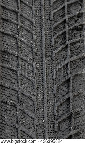 Traces Of Car Tire Tread In The Ground. Pattern. Dark Abstract Background. Imprint Of Wheels. Textur
