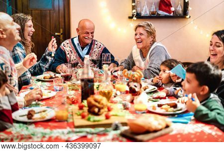 Multi Generation Family Having Fun At Christmas Dinner Event - Winter Holiday And X Mas Concept Abou