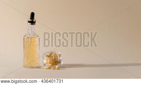 Gel Serum In A Glass Bottle With A Pipette And Capsules With Serum For Skin Care Of The Face, Eyes, 