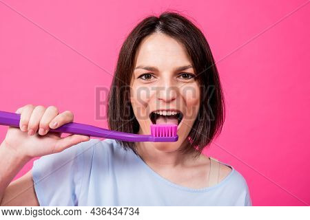 Beautiful Happy Young Woman With Big Toothbrush On Blank Pink Background