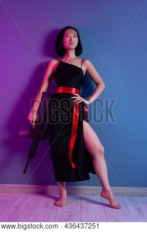 Asian Woman With A Machine Gun Aims For Shooting