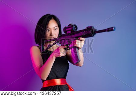 Asian Woman With A Machine Gun Aims For Shooting
