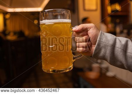 Man Holding Cold Beer Glass With His Hand. Refresment Cold Lager Beer.