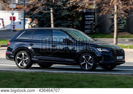 Moscow; Russia - October 14; 2021: Black Audi Q7  Is Driving Fast On The Street On A Warm Autumn Day
