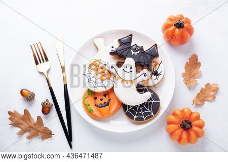 Halloween Table Setting With Gingerbread Cookies On White Plate And Cuterly On White Background. Bri
