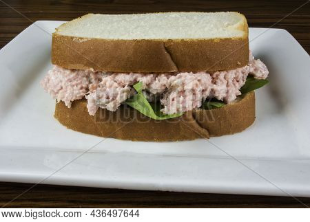 Ham Salad Sandwich On A Plate Against A Black Back Ground