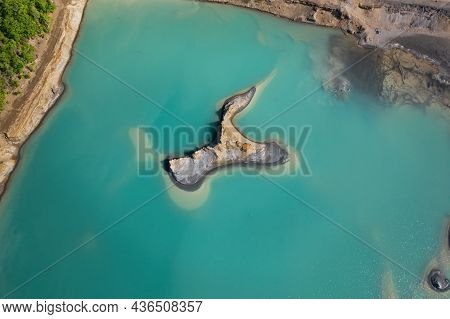 Drone View Of The Turquoise Lake Formed As A Result Of Mining Waste