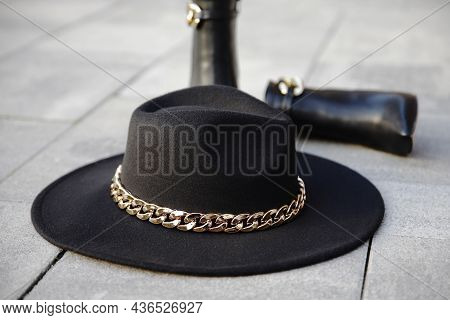 Stylish Black Hat With Leather Boots In The Background In The Street